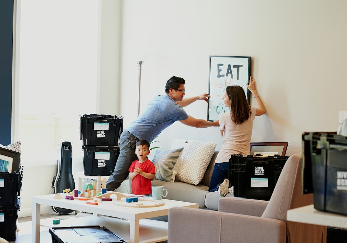 how-much-money-do-i-need-in-my-smsf-to-buy-property couple stling their living room up with their kid