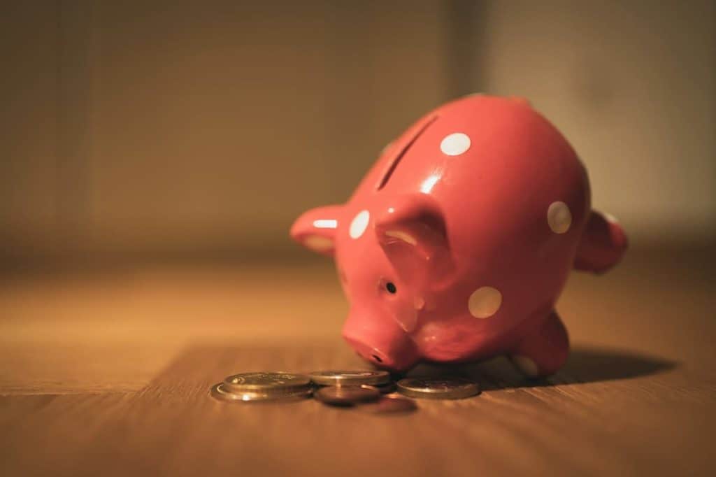 Pink piggy bank with coins on wooden floor – how much can I borrow on 150k in Australia